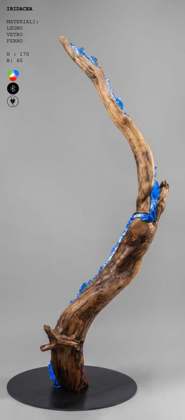 Wooden sculpture with blue accents on a gray background