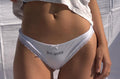 White underwear with 'Bon appetit' text on a neutral background